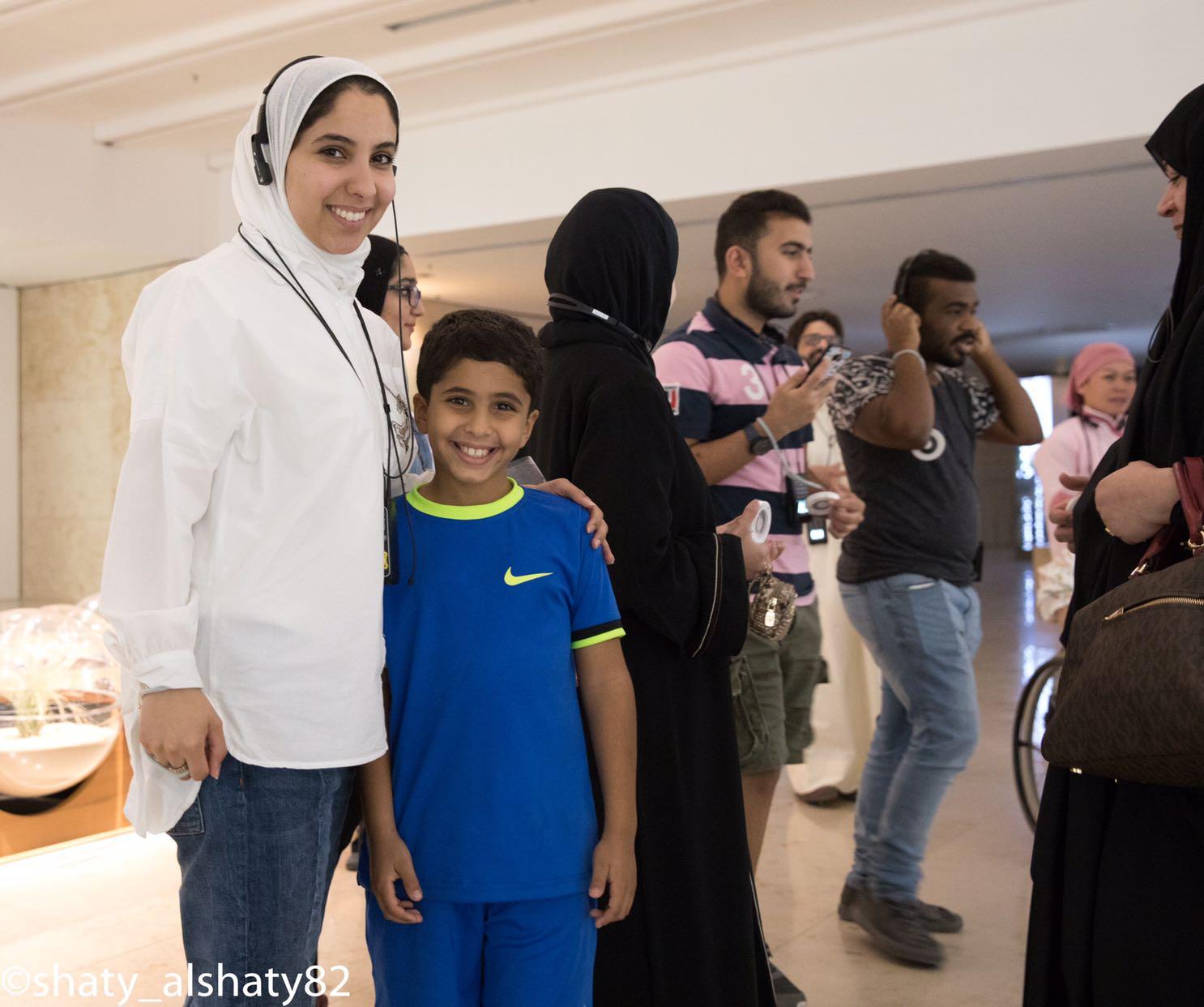 Facilitator and young member smiling together during a TGI club outing.
